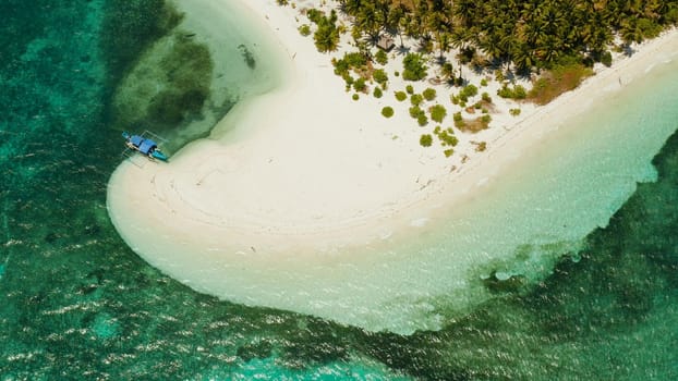 Sandy beach and tropical island by atoll with coral reef, top view. Patongong Island with sandy beach. Summer and travel vacation concept.