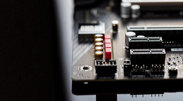 The motherboard on a table close-up, inside of a desktop computer showing chips, circuit boards and components with copy space.