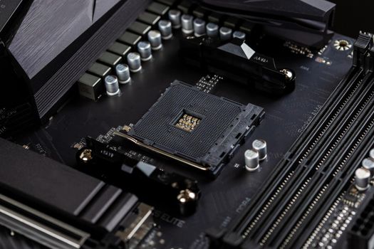 Motherboard on a table close-up, inside of a desktop computer showing chips, circuit boards and components