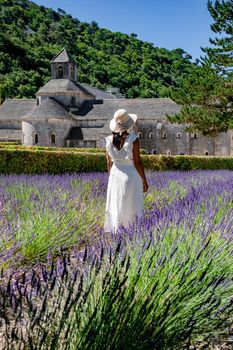 Senanque Abbey Gordes Provence Lavender fields Notre-Dame de Senanque, blooming purple-blue lavender fields Luberon France. Europe, couple visiting the Provence France, men , woman mid age on vacation