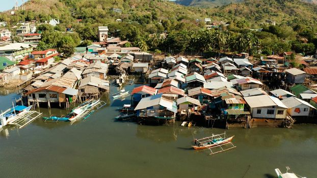 Coron city with slums and poor district. Old wooden house standing on the sea in the fishing village. Houses of local poor people.Busuanga, Coron, Philippines. houses community standing in water in fishing village.