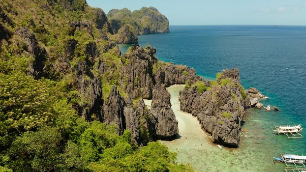 aerial view of tropical lagoon with sandy beach surrounded by cliffs. El nido, Philippines, Palawan. beautiful lagoon and karst scenery.
