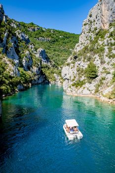 cliffy rocks of Verdon Gorge at lake of Sainte Croix, Provence, France, Provence Alpes Cote d Azur, blue green lake with boats in France Provence. Europe June 2020