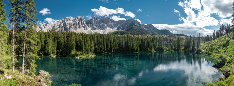 The majestic Lake of Lago di Carezza, beautiful green and turquoise colors in Dolomites mountains Italy,South tyrol, Italy. Landscape of Lake Carezza or Karersee and Dolomites in background Dolomites 