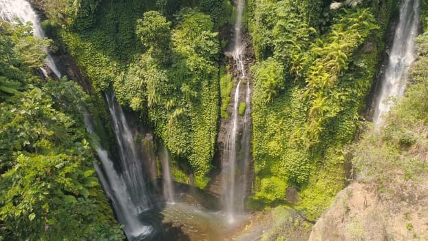 waterfall in green rainforest. Aerial view triple tropical waterfall Sekumpul in mountain jungle. Bali,Indonesia. Travel concept.