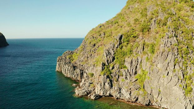 Seascape with tropical rocky islands, ocean blue water, aerial view . islands and mountains covered with tropical forest. El nido, Philippines, Palawan. Tropical Mountain Range