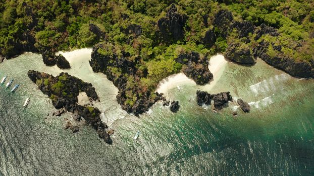 Tropical lagoon with sandy beach surrounded by cliffs. El nido, Philippines, Palawan. beautiful lagoon and karst scenery.