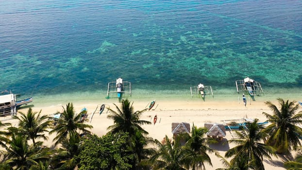 landscape of tropical island beach with perfect sky. Island with a tropical beach and turquoise lagoons. Digyo Island, Philippines. Summer vacation and tropical beach concept.