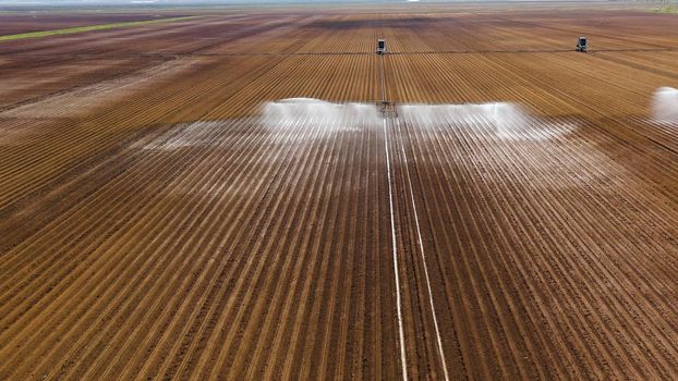 aerial view Center pivot agriculture irrigation machine of crops. An irrigation pivot watering agricultural land. Irrigation system watering farm land.