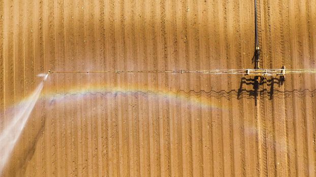 aerial view Center pivot agriculture irrigation machine of crops. An irrigation pivot watering agricultural land. Irrigation system watering farm land.