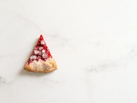 Perfect slice of raspberry galette. Delicious rustic homemade tart with frozen or fresh raspberries, white marble background. Beautiful piece of galette with raspberries,copy space. Top view flat lay