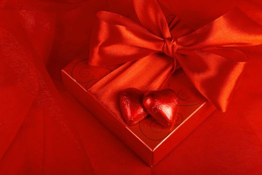 Valentine's day concept, gift with candle on a red background