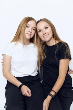 mom and daughter hug friendship studio isolated background. High quality photo