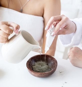 Spa and wellness concept. Self care. Women hands making facial mask doing spa procedures