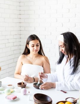 Spa and wellness concept. Self care. Women hands making facial mask doing spa procedures