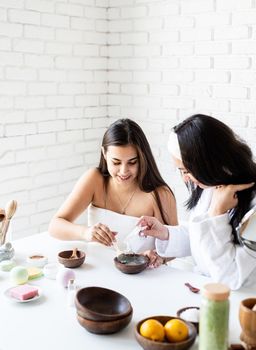 Spa and wellness concept. Self care. Women hands making facial mask doing spa procedures