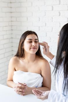 Spa and wellness concept. Self care. two beautiful women applying facial cream doing spa procedures