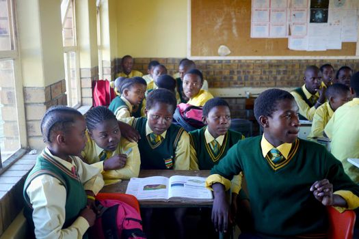 Children crammed into an overcrowded classroom in South Africa