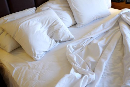Luxury hotel bedroom with white linen