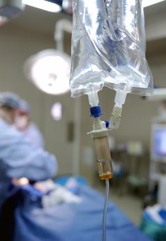 Heart monitor and IV drip in hospital operating theatre