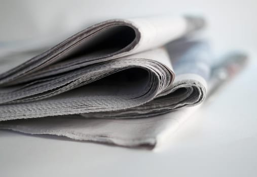 Stack of newspapers on white background