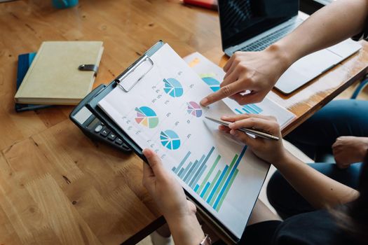 Close up Business People Meeting to analyse and discuss and brainstorming the financial report chart data in office Financial advisor teamwork and accounting concept.