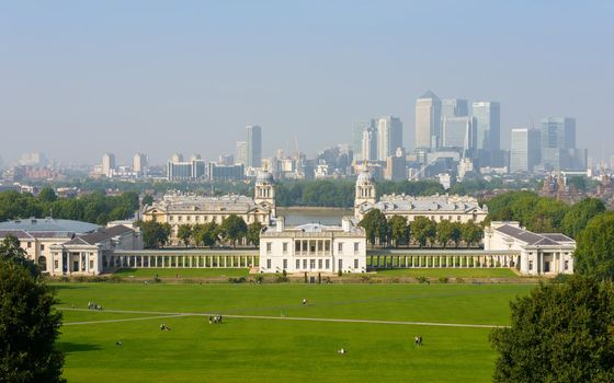 GREENWICH, UK - CIRCA SEPTEMBER 2013: The National Maritime Museum and Canary Wharf in the background, seen from Greenwhich Park.