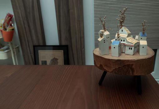 Many little houses made in wood on wooden table for house decoration. Copy space, No focus, specifically.