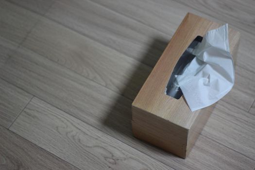 Tissue box of white facial tissue paper on wooden table