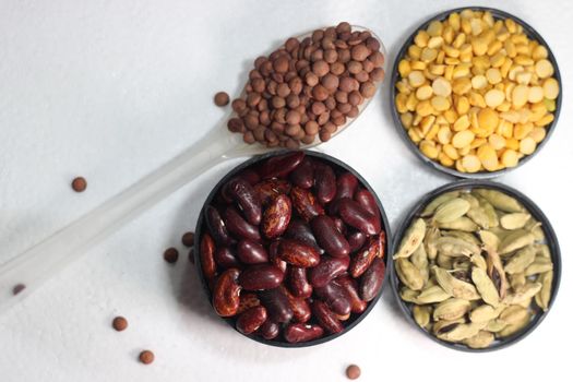 Top view of assortment of cereals, and cardamom. Collection of different spices and cereals.