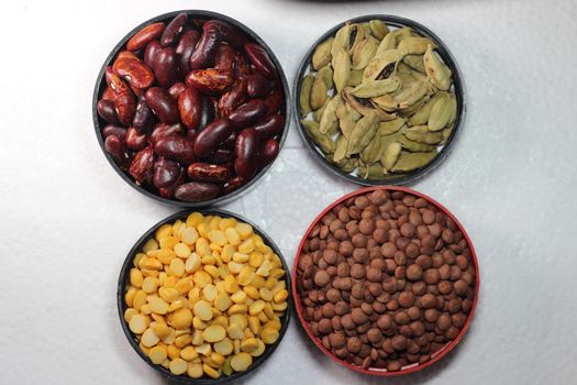 Top view of assortment of cereals, and cardamom. Collection of different spices and cereals.