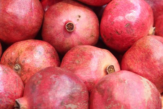 Heap of Pomegranates in market. Pomegranate fresh fruit background pattern.