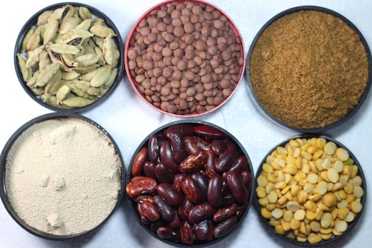 Top view of assortment of cereals, and cardamom. Collection of different spices and cereals.