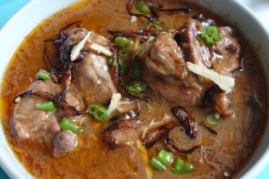 Closeup view of traditional Pakistani Haleem dish with salad and Lemon juice.