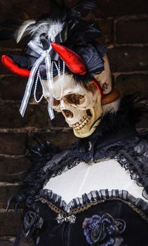 Female mannequin with gothic clothes, skull and red horns