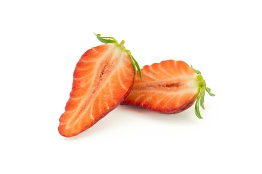 Ripe juicy strawberry fruit cut in half isolated on white background