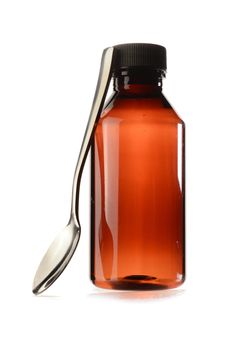 A medicine bottle and spoon isolated over a white background.