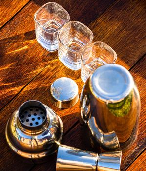 Bar ustensils, drink concept. Cocktail shaker accessories on a wooden board.