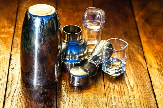 Bar ustensils, drink concept. Cocktail shaker accessories on a wooden board.