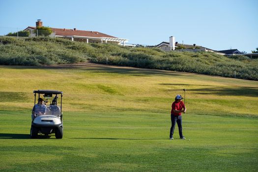Golfer on the golf course. Golf course with a rich green turf beautiful scenery. San Diego, California, USA. January 2nd, 2020