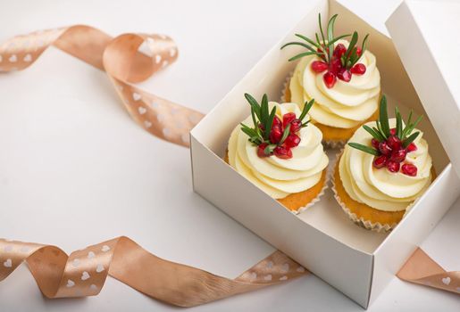 Valentines cupcakes with vanilla in a box on a white background with ribbon