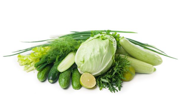 Composition with raw vegetables isolated on white.