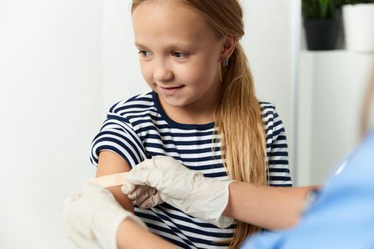 the doctor seals the child's hand with a plaster treatment. High quality photo