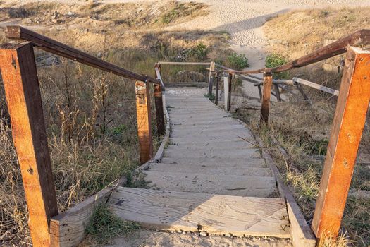 A broken wooden staircase descends. Stock photo.
