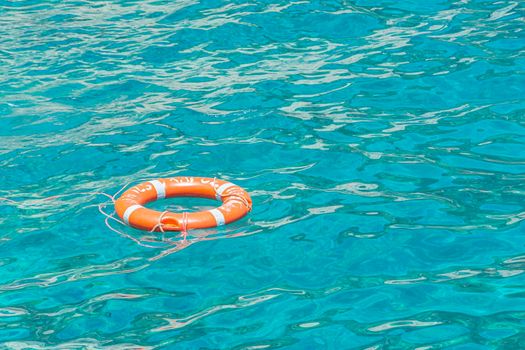 Lifebuoy on the surface of the water. Stock photo.