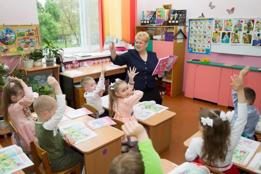 Belarus, the city of Gomel, May 10, 2019. Open day in kindergarten.Primary school teacher and children at their desks.