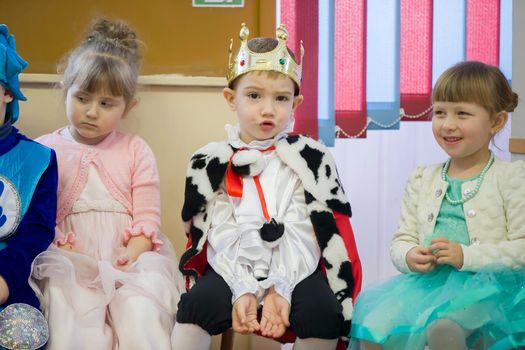 Belarus, the city of Gomil, December 27, 2018. Morning party in kindergarten.Funny boy in the carnival costume of the king at the Christmas matinee in kindergarten.