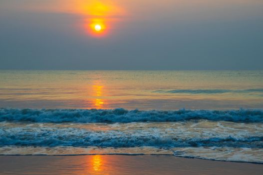 ocean beach sunrise. Beautiful beach scenery with calm waves and soft sandy beach. Empty tropical landscape,  Colorful nature sea sky