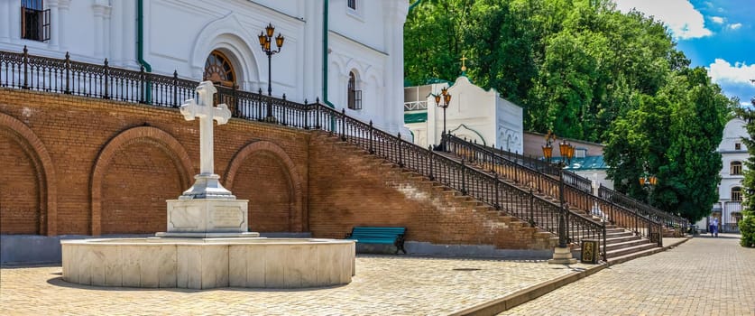 Svyatogorsk, Ukraine 07.16.2020.  Memorial cross at the entrance to the Assumption Cathedral in the Svyatogorsk Lavra on a sunny summer day