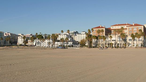California summertime beach aesthetic, sunny blue sky, sand and many different beachfront weekend houses. Seafront buildings, real estate in Santa Monica pacific ocean resort near Los Angeles CA USA.